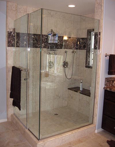 Frameless glass shower enclosure